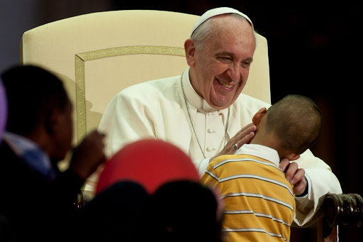 Pope Francis greets a family