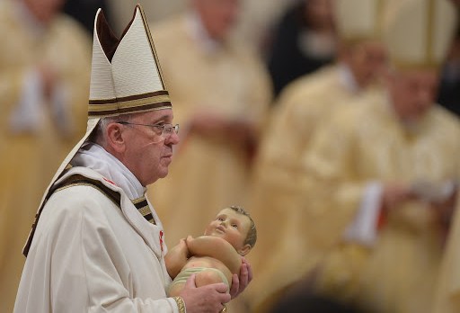 Pope Francis holds the unveiled baby Jesus during a Christmas Eve mass &#8211; it