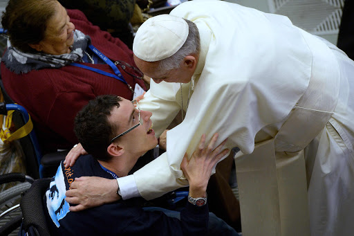 Pope Francis meets a disabled man &#8211; AFP
