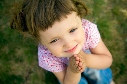 pretty young girl praying with her hands held together &#8211; it