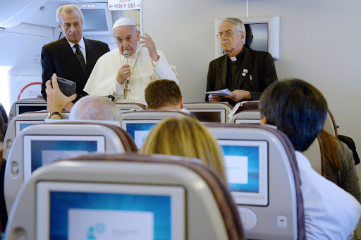 Pope returning to Rome from Korea in the plane
