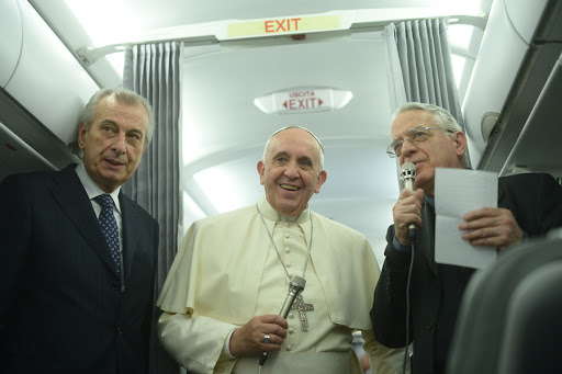 Pope Francis (C) addresses journalists aboard a plane at the end of his three day visit in Turkey, on November 30, 2014. &#8211; it