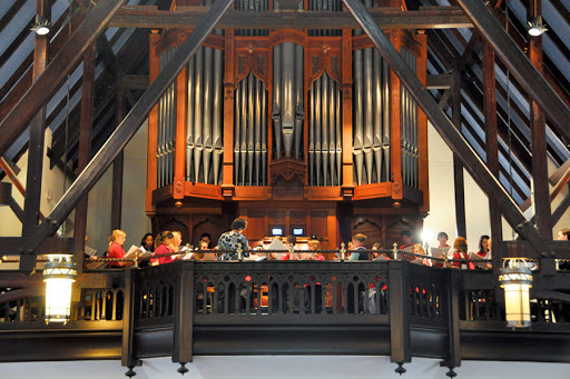 A musical group singing in a mass with an organ