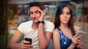 Secretive Couple with Smart Phones in Their Hands – Young adult couple has privacy problems with modern technology – it