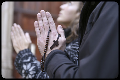 Couple praying with rosary in hand © Mangostock / Shutterstock &#8211; it