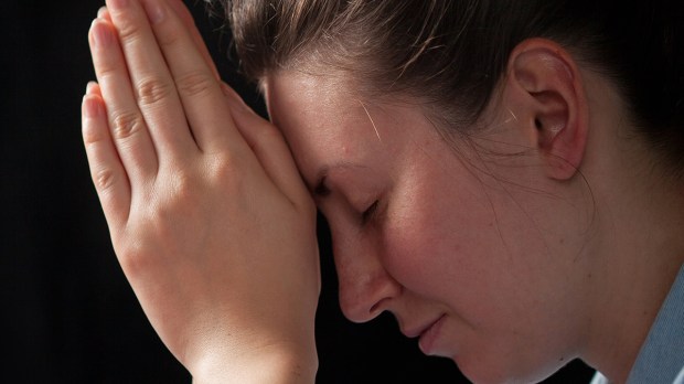 web-woman-praying-closeup-hands-eyes-shut-4max-shutterstock_429133354