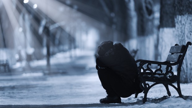 Depressed woman in front of a bench