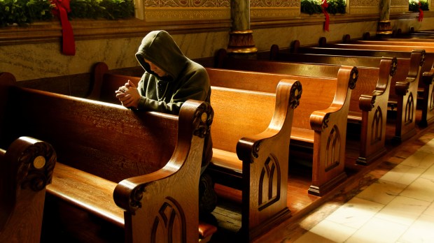 WEB PERSON PRAYING KNEES CHURCH Waddell Images:SHUTTERSTOCK CC