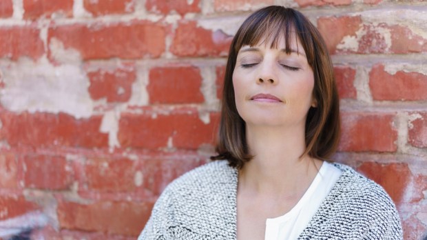 WEB WOMAN PRAY INTROSPECTION BRICK WALL ©Racorn:Shutterstock