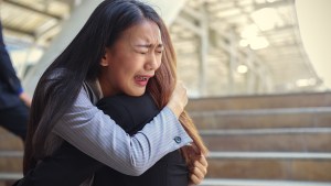 WEB3-SAD-CRYING-HUG-EMBRACE-WOMAN-shutterstock_609623909-Shutterstock