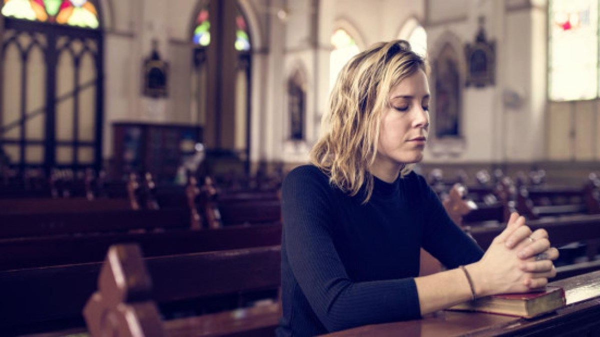 web3-woman-praying-church-mass-bible-shutterstock