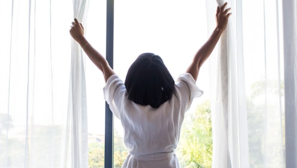 WOMAN OPENING WINDOW