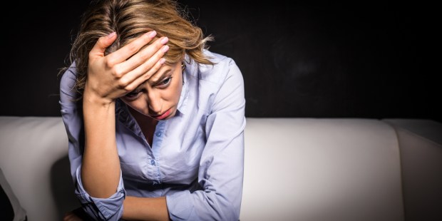 ANXIOUS WOMAN SITTING