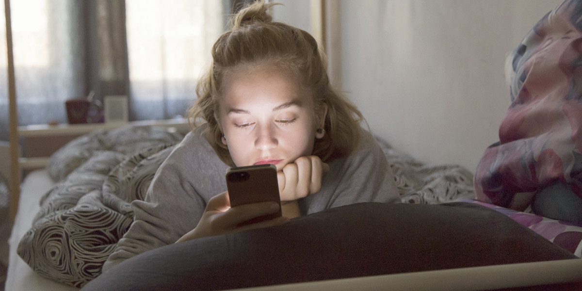 web3-teen-girl-bed-phone-smartphone-sad-unhappy-anxious-shutterstock