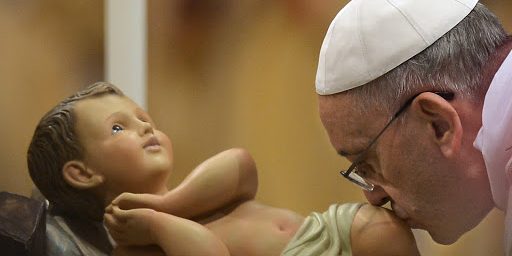 Pope Francis kisses the unveiled baby Jesus during a Christmas Eve mass at St Peter’s Basilica – pt