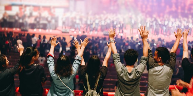 young praying raised hand