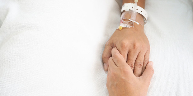 web3-hands-touching-cancer-patient-pain-hospital-bed-shutterstock_509368501-benchawan-suasuk-ai
