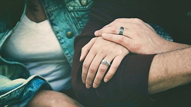 COUPLE HOLDING HANDS