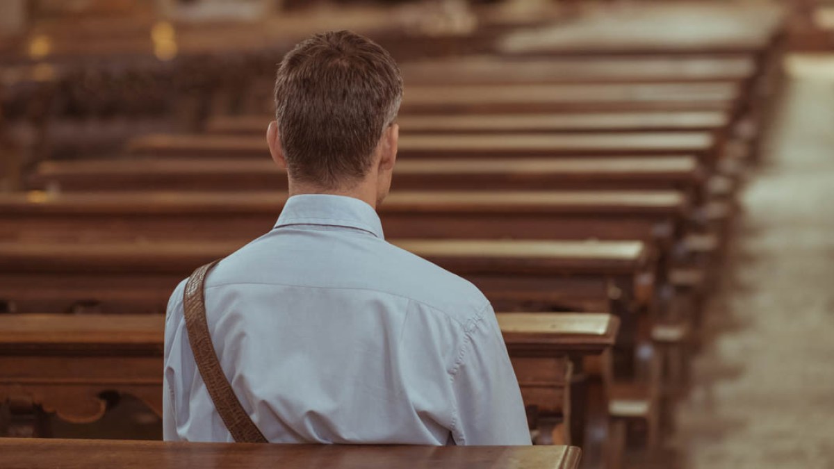MAN SITTING IN PEW