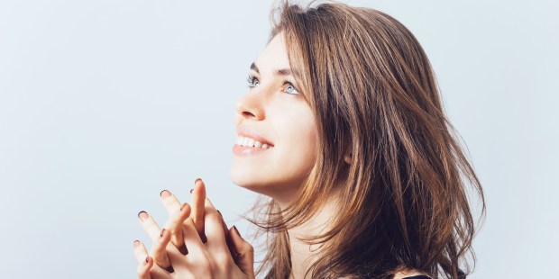 WOMAN PRAYNG SMILING