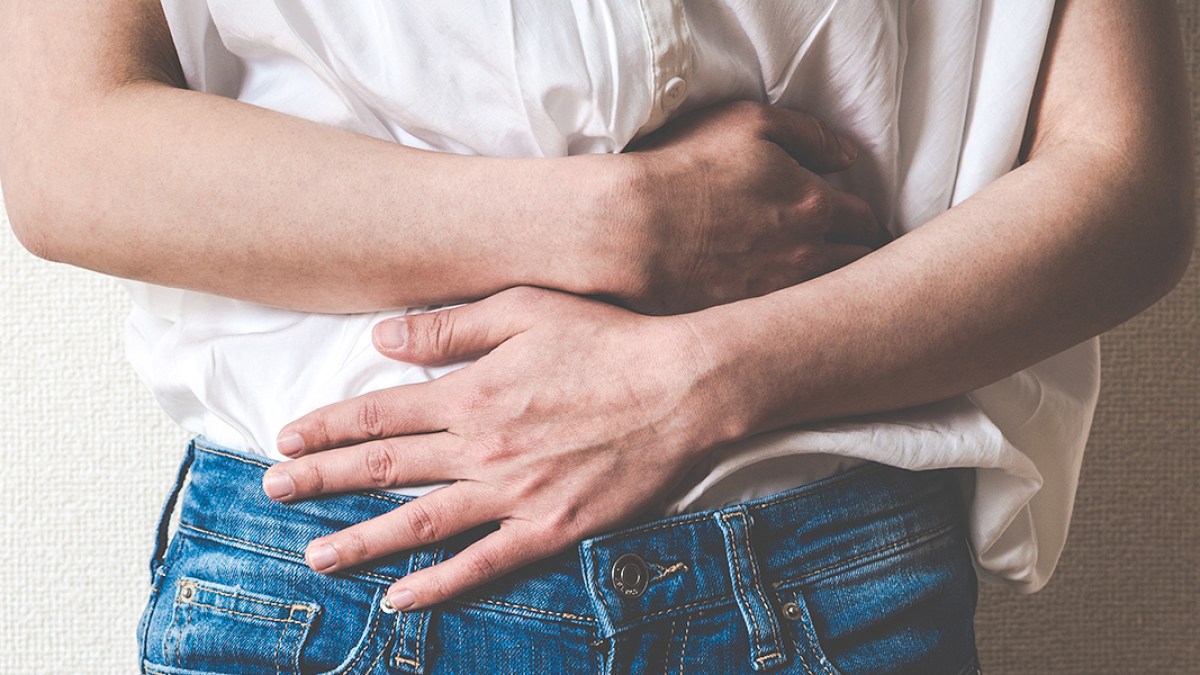 WOMAN HOLING STOMACH