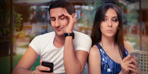 Secretive Couple with Smart Phones in Their Hands &#8211; Young adult couple has privacy problems with modern technology &#8211; es