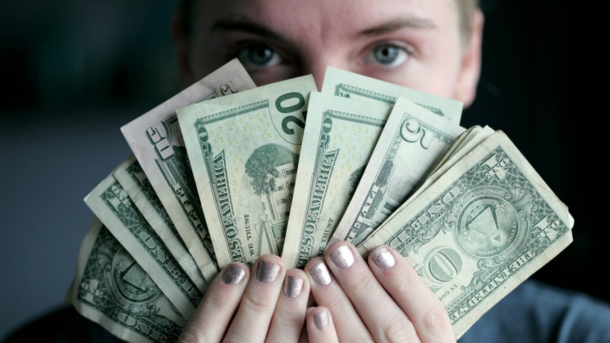 WOMAN HOLDING MONEY