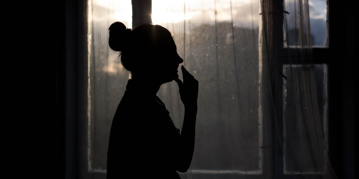 WOMAN,STANDING IN THE DARK