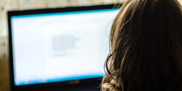 girl behind laptop