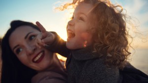 web2-beautiful-mother-and-her-little-daughter-are-having-fun-together-on-the-lake-ladoga-in-russia-during-the-sunset.-blurred-image-with-toning-shutterstock_1336361084.jpg