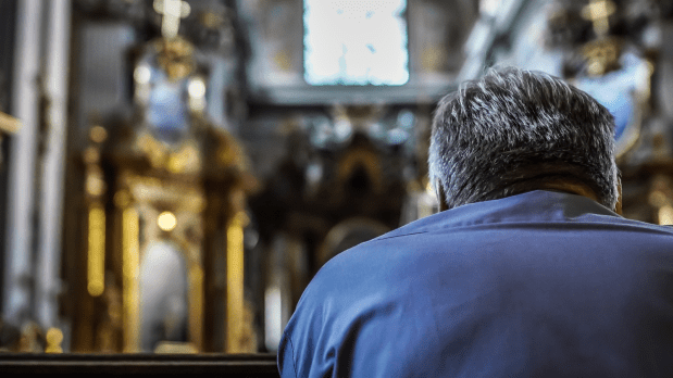 man praying in a church