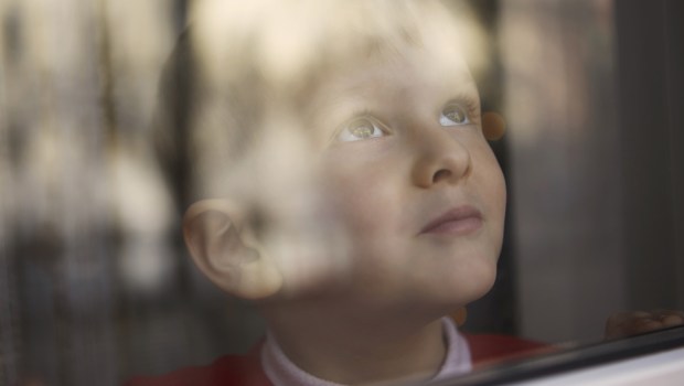 young boy looking outside