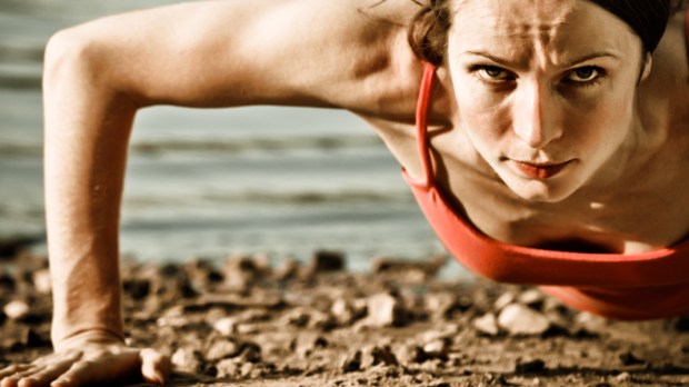web3-Strong-woman-doing-pushup-at-the-beach