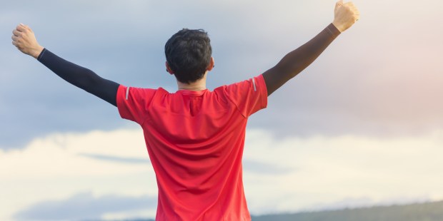 young man, arms to the sky,