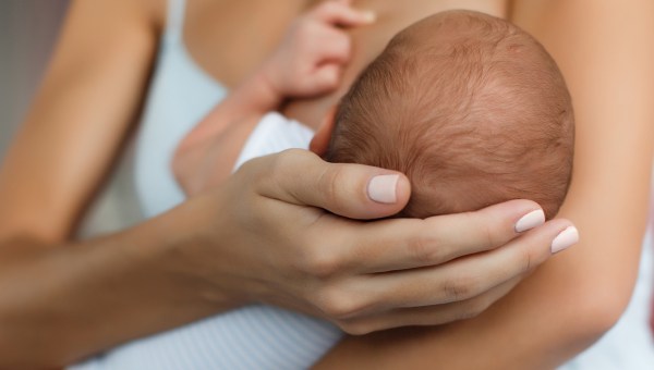 mother breastfeeding newborn baby