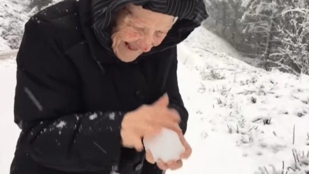OLD WOMAN, PLAYING, SNOW