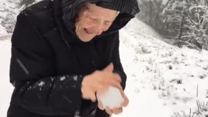 OLD WOMAN, PLAYING, SNOW