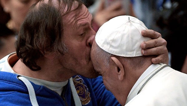 Pope Francis is kissed by a person