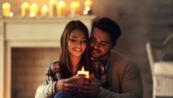 COUPLE AT HOME HOLDING CANDLE