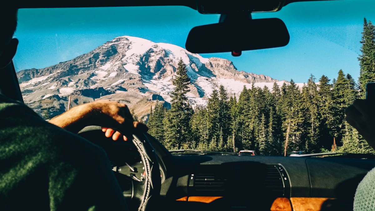 MAN, DRIVING, MOUNTAINS