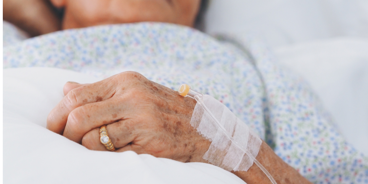 WEB3-Senior-woman-laying-on-bed-in-hospital-roomshes-sick.-Shutterstock_1054837748.jpg
