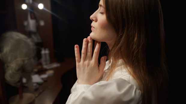 woman in white long sleeve shirt praying