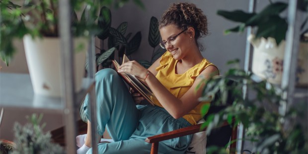 WOMAN READS BOOK,