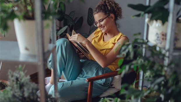 WOMAN READS BOOK,