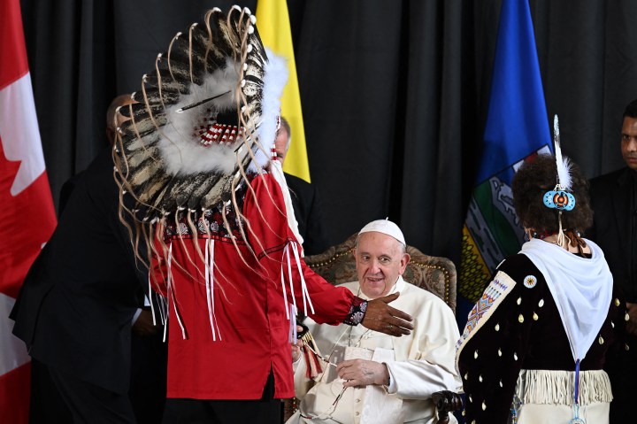 Pope-Francis-speaks-with-member-of-an-indigenous-tribe-during-his-welcoming-ceremony-at-Edmonton-International-AFP