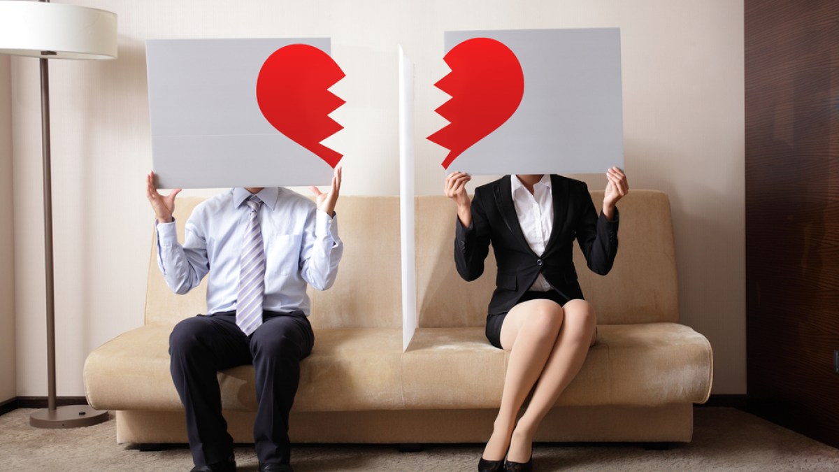 couple holding billboard sign with break love heart_shutterstock_201882463.jpg