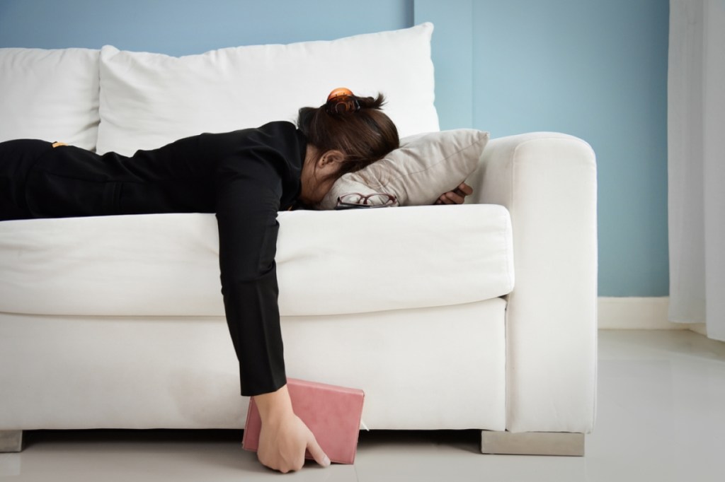 Tired woman lying on the couch