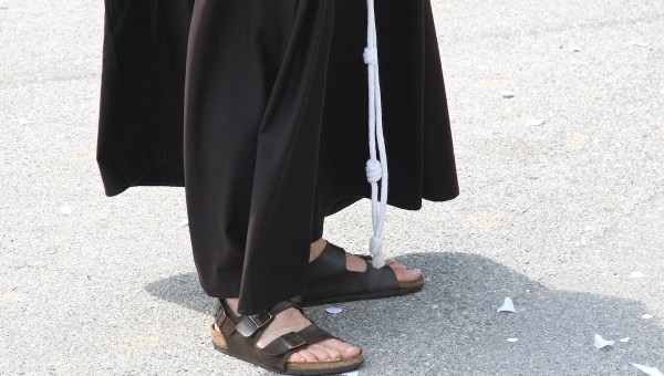 Barefoot with sandals and the habit of a Franciscan Friar