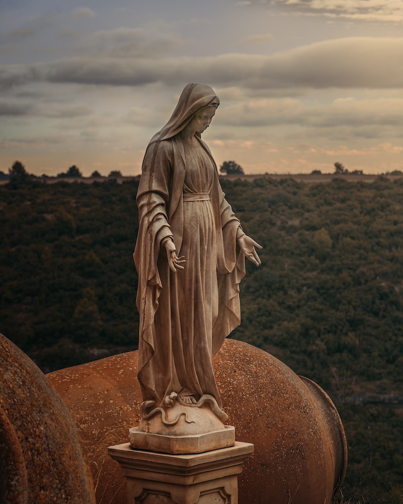 Mary statue field snake granite forest