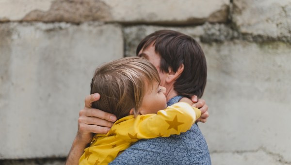 man dad having quality time with their kid son boy six year old hug on arms happy father playing together with child real life authentic day to day fatherhood moments